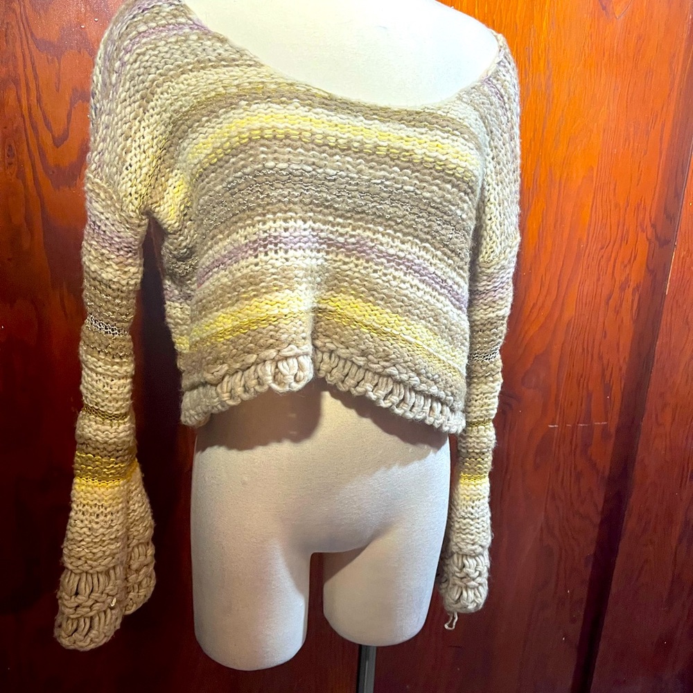 FREE PEOPLE  cropped sweater with a butterfly sleeve. Tiny hole/back